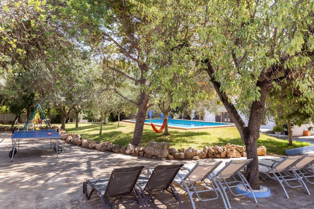a group of chairs and a table in a park at Finca Can Lluc in Alaró