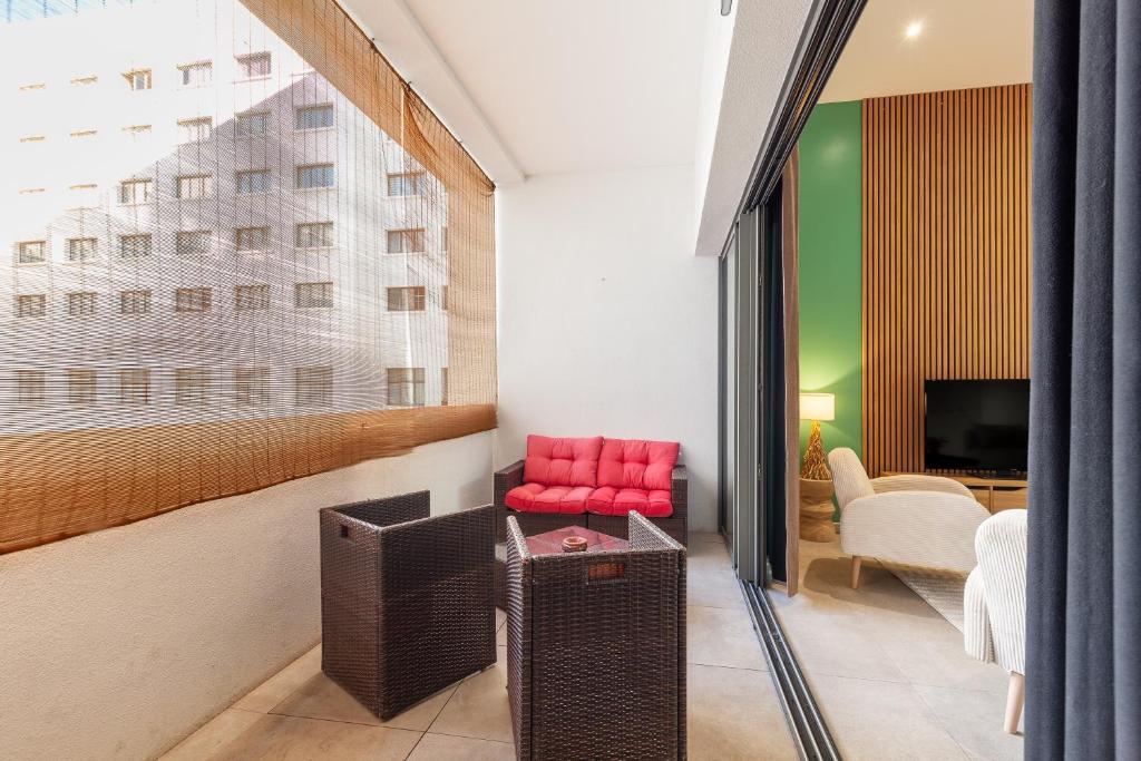 a living room with a red chair and a television at Le Castel in Marseille