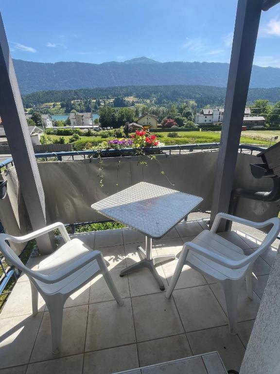 a table and chairs on a balcony with a view at Appartment Isabelle Sky in Lake Pressegg