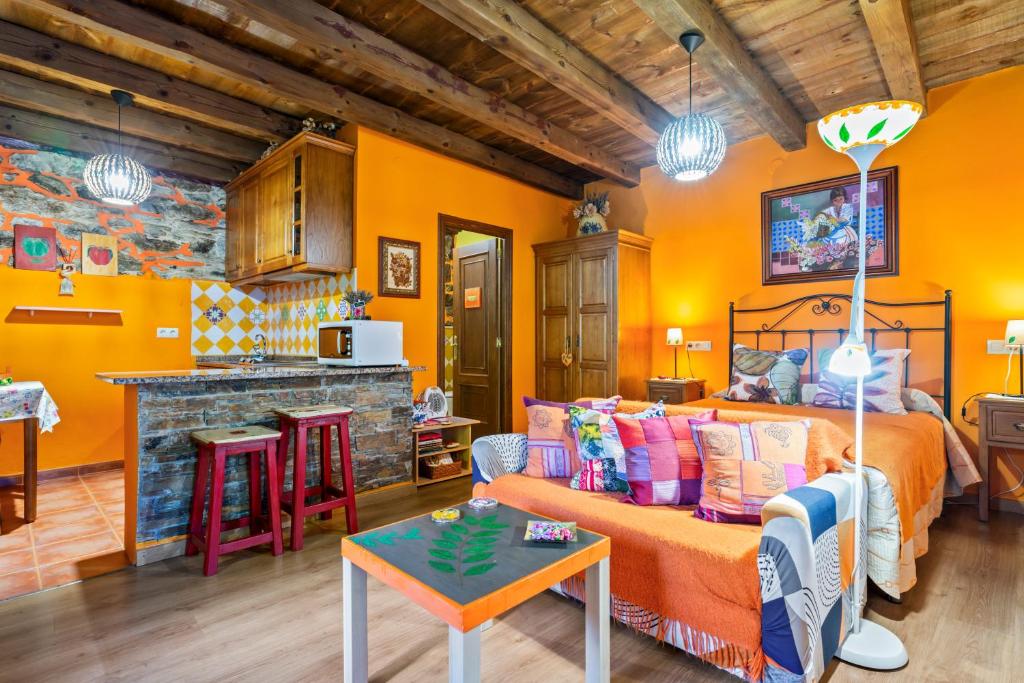 a living room with a bed and a kitchen at Loureiro in Vega de Logares