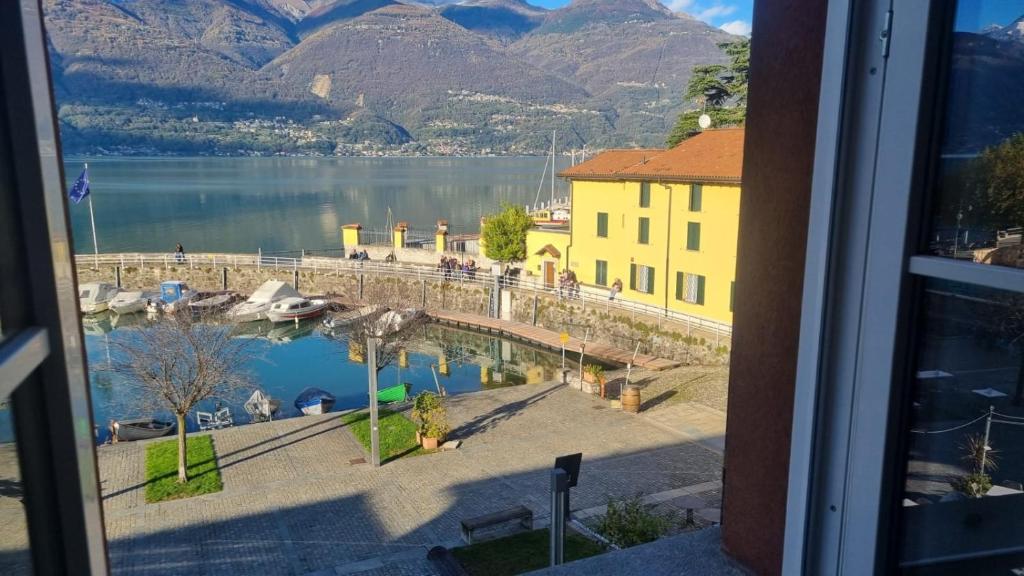 a view of a body of water with a bridge and mountains at Colico Center in Colico