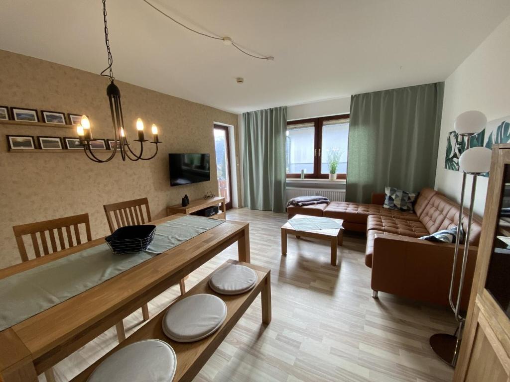 a living room with a dining table and a living room at Fewo Am Edersee in Edertal