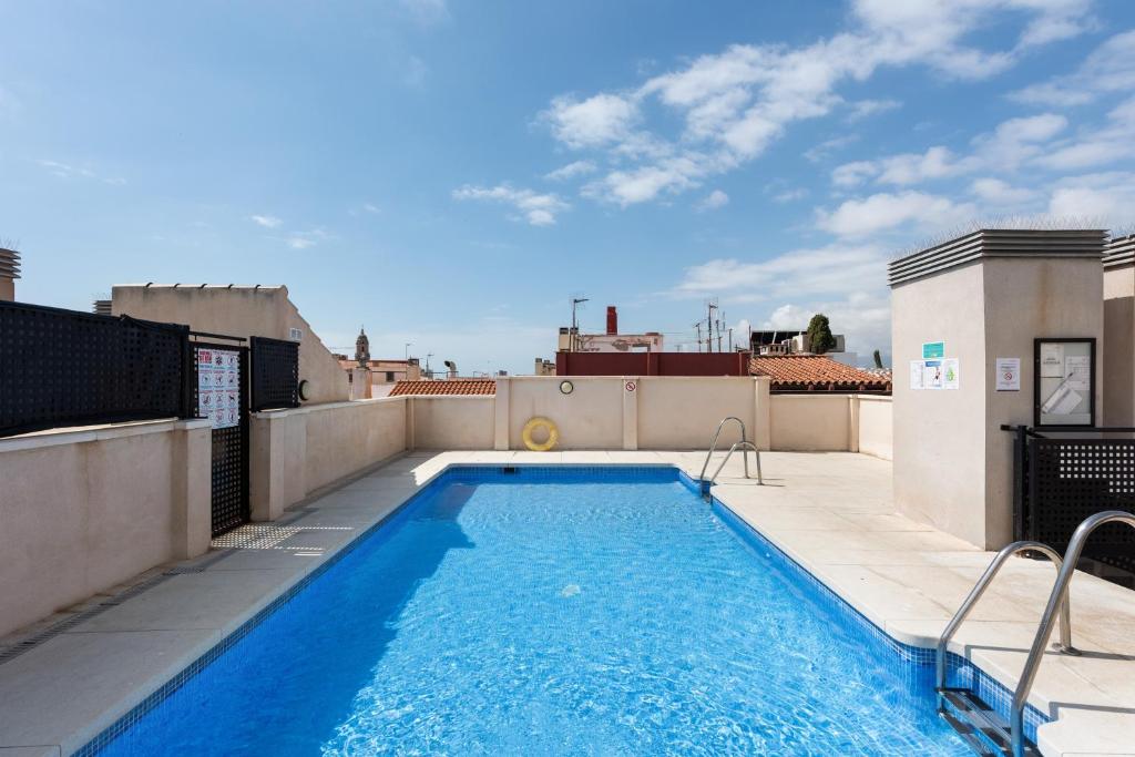 a swimming pool on the roof of a building at Suite Jinetes in Málaga