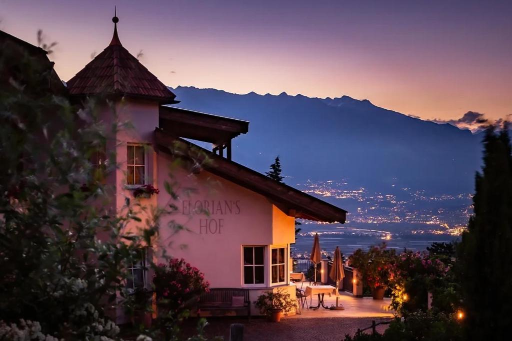 a building with a sign that reads always hot at Florianshof in Tesimo