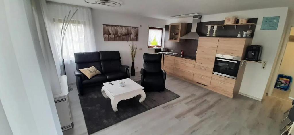 a living room with a couch and a table at Ferienwohnung Küssaberg in Küssaberg