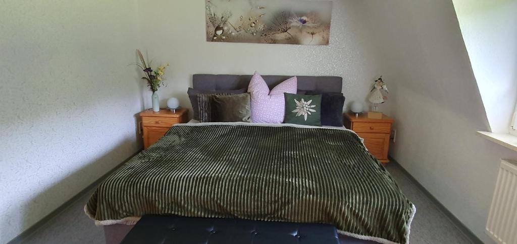 a bedroom with a large bed with purple pillows at Fewo D und R Schwesternherz in Naumburg