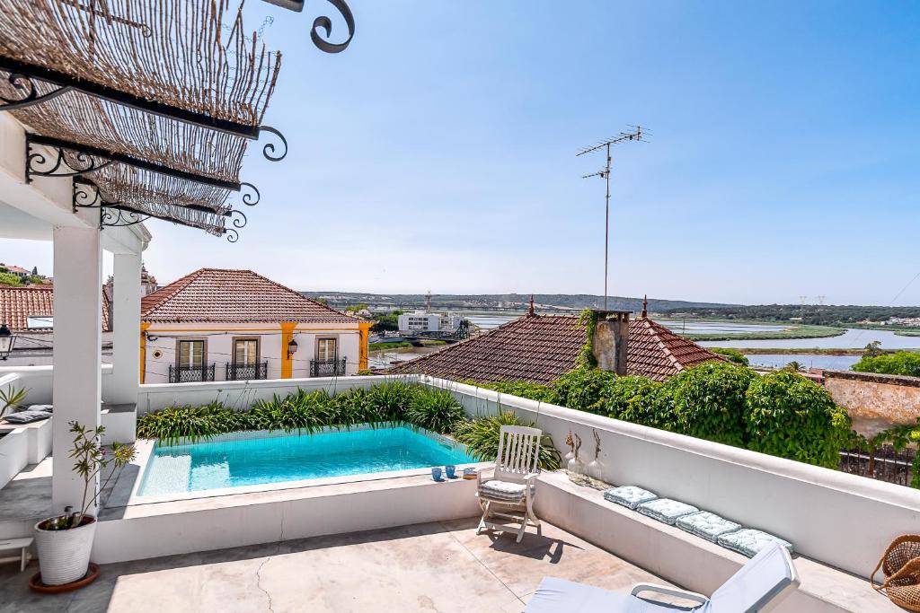 a swimming pool on the balcony of a house at Calçada in Alcácer do Sal