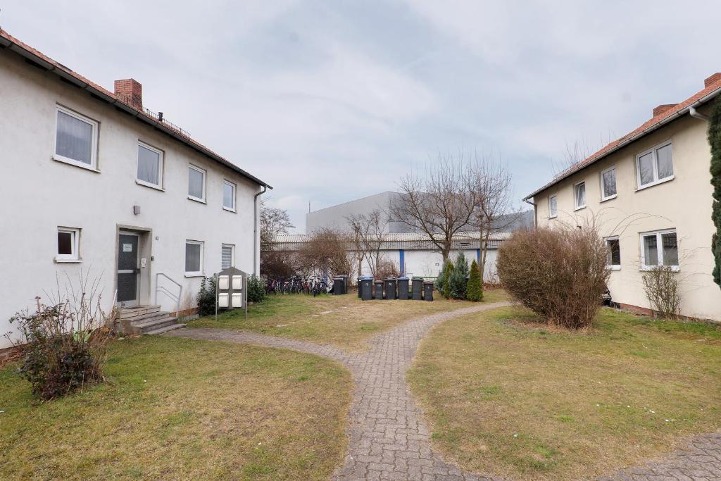 a walkway through a yard next to two houses at Yellow in Miltenberg