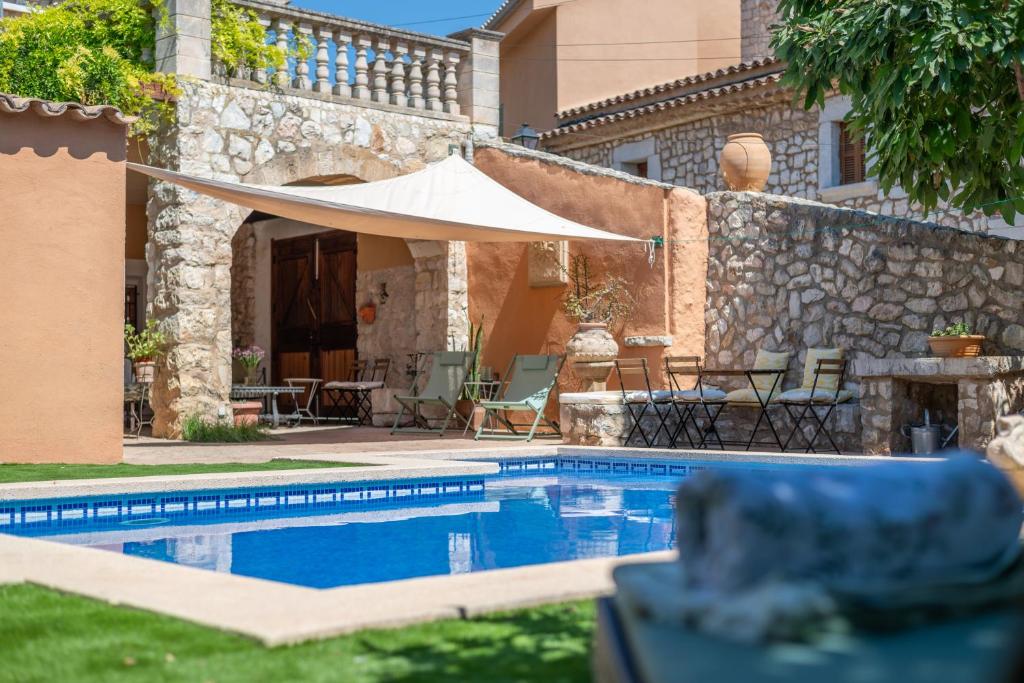 a villa with a swimming pool and a house at Ca'n Blanch in Biniamar