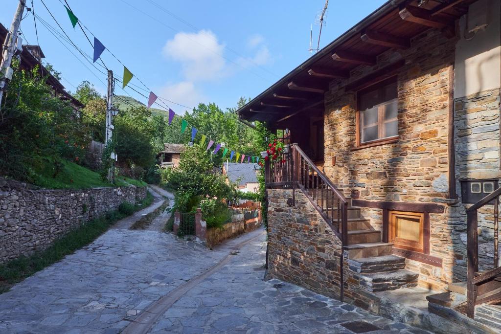 a stone house with a staircase on the side of it at El Pajariel ll in Valdecañada