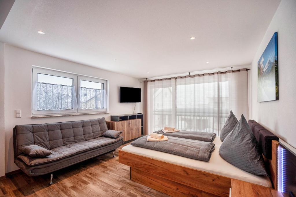 a living room with a couch and a tv at Ferienwohnung Legau in Legau
