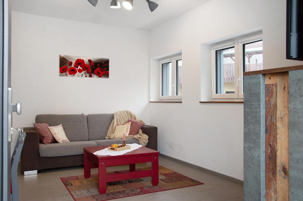 a living room with a couch and a table at Mohnblume in Unterwittighausen