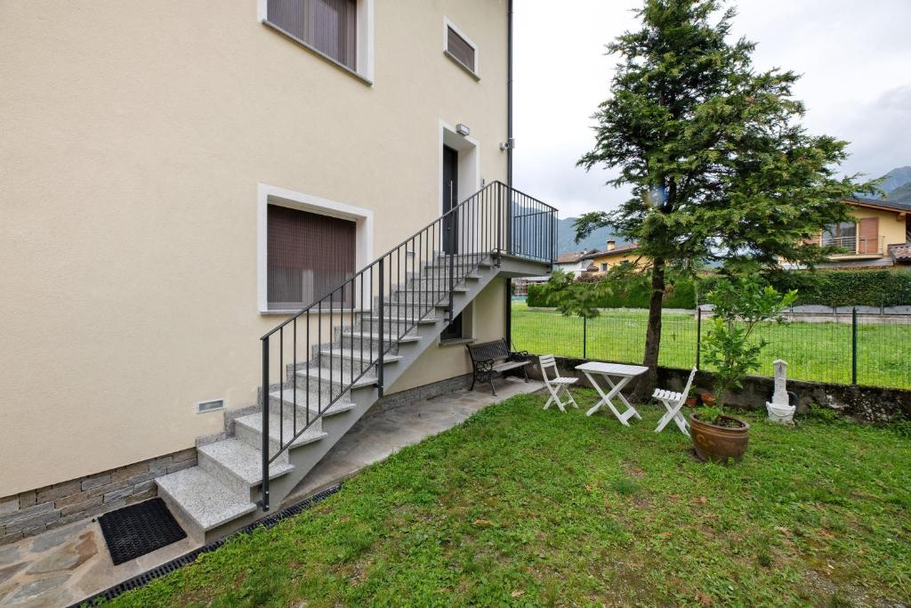 a house with a staircase next to a yard at La Villa di Ludo in San Cassiano