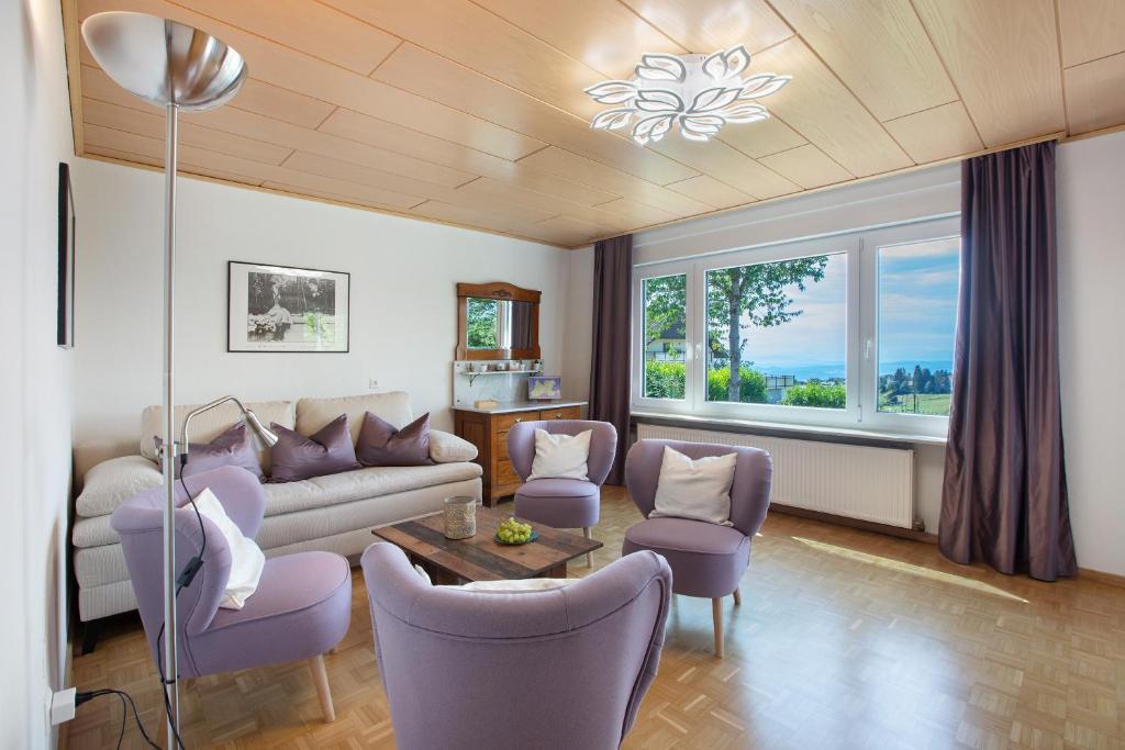 a living room with a couch and chairs and a table at Familie Quednow - Im Algi in Görwihl