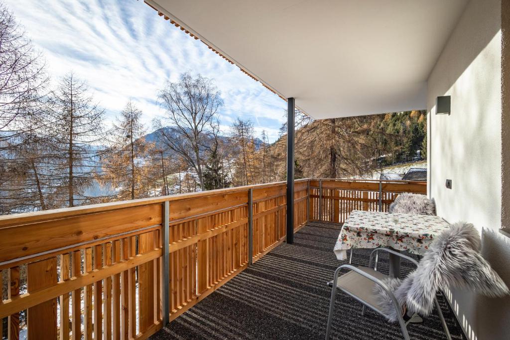 a balcony with a table and chairs and a view at App Hubertus - Sonnklar in Sand in Taufers