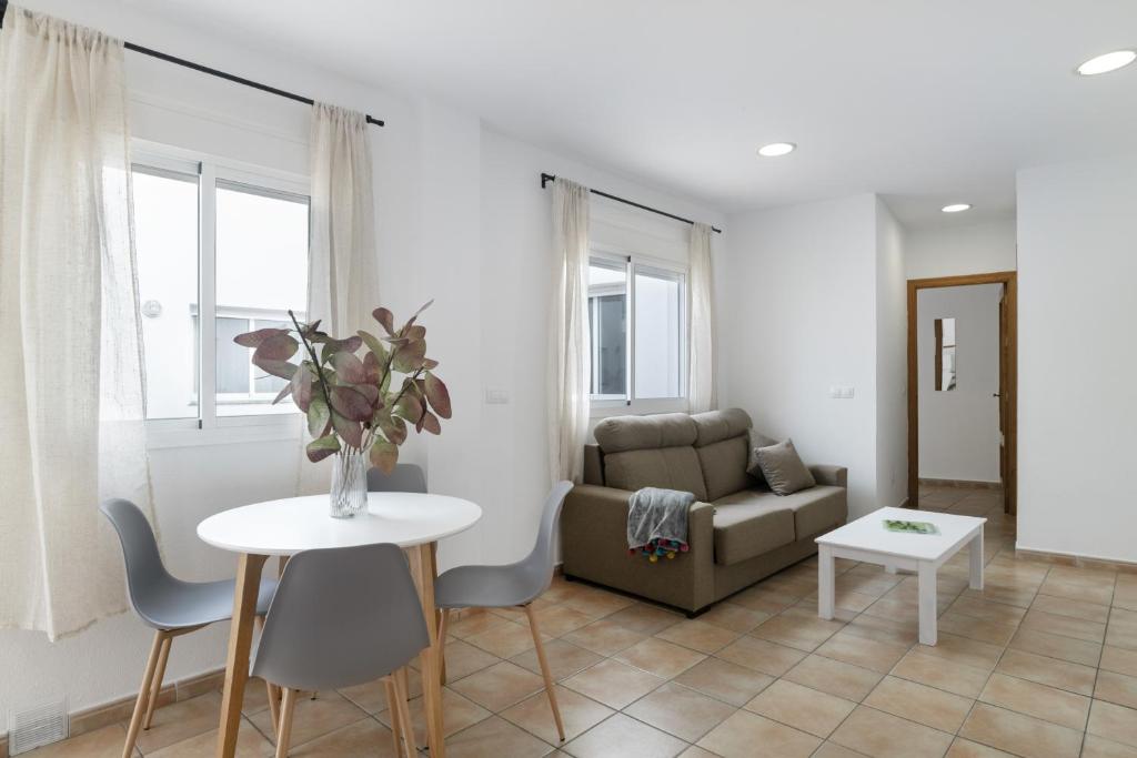 a living room with a couch and a table at Apartamento Perez Zara 3 in Conil de la Frontera