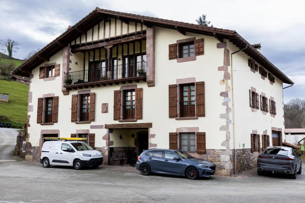 two cars parked in front of a building at Matxingonea 2 in Urdax