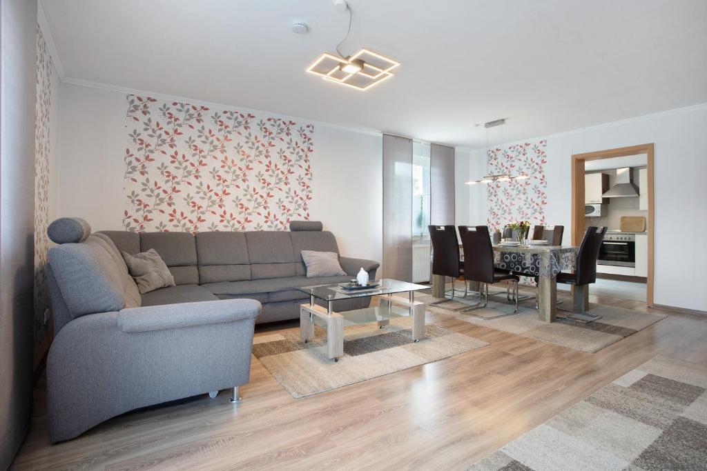 a living room with a couch and a dining room at Bungalow Bei Rügen in Sundhagen-Niederhof