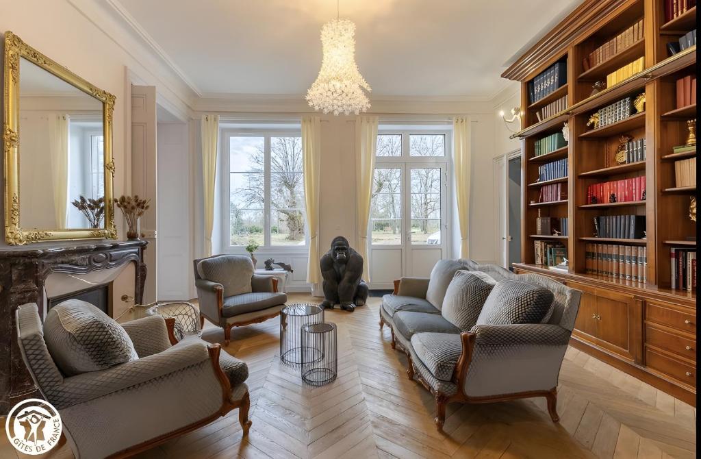 a living room with two couches and a fireplace at Château De Saint Mayeul in Joze