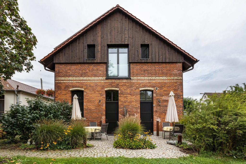 a brick house with a gambrel roof at Die Ferienwohnung in Reichenau