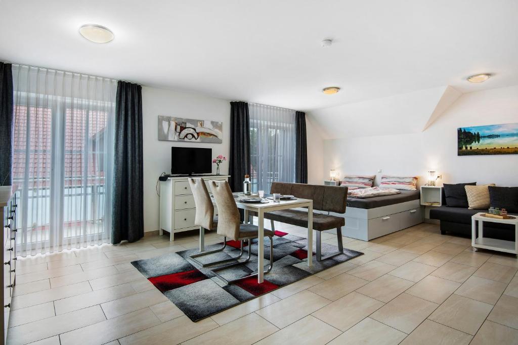 a living room with a table and a couch at Appartement Mia in Ihrlerstein