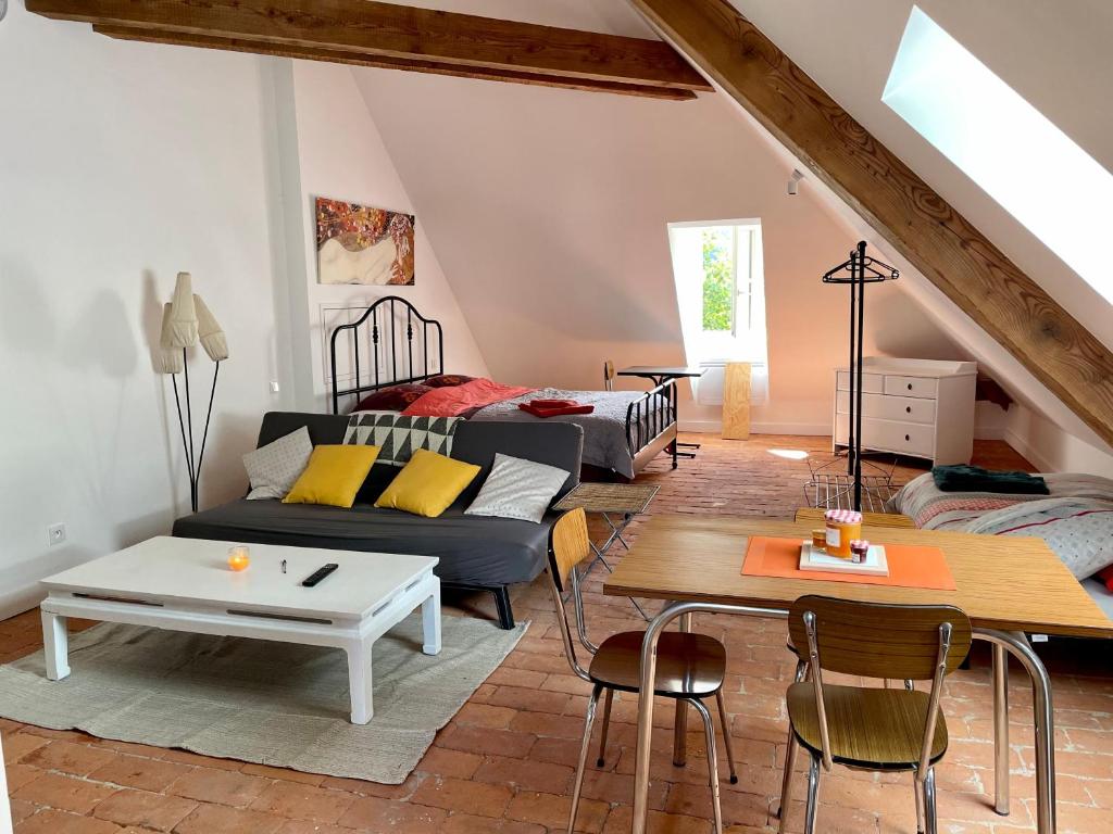 a living room with a couch and a table at Studio Hyper-Centre Villa Isabelle in Allevard