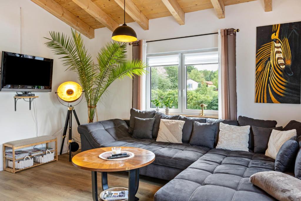 a living room with a couch and a table at Urlaub im Garten Gottes in Klosterlangheim