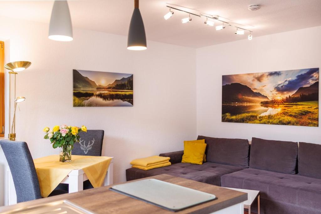 a living room with a couch and a table at Gästehaus Wolfgang Weitsee in Ruhpolding