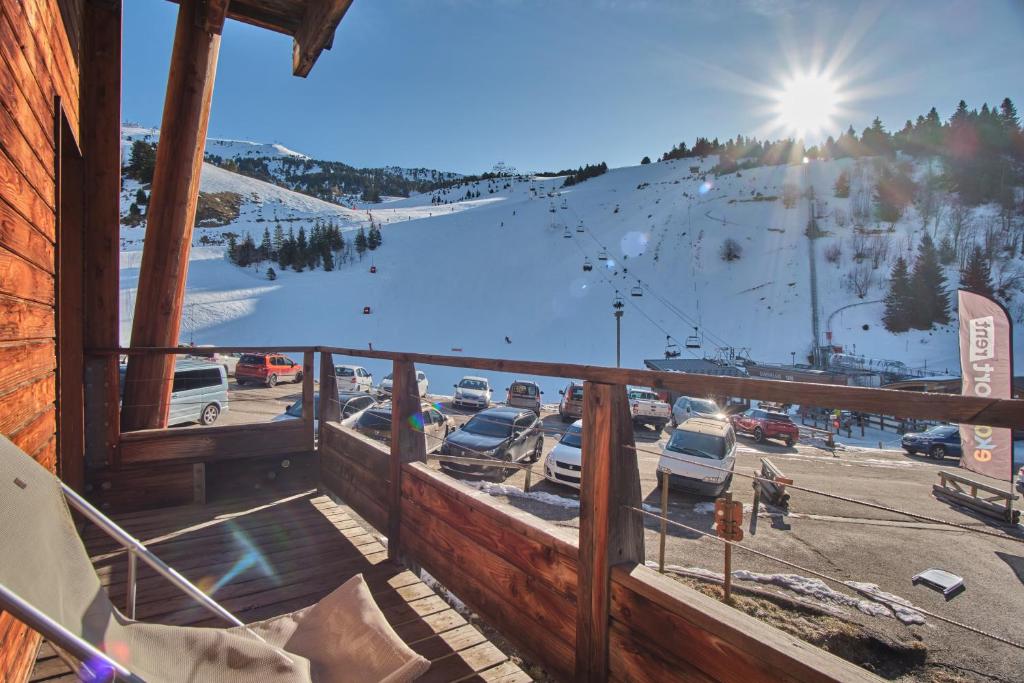 a balcony with a view of a parking lot at Les Airelles in Chamrousse