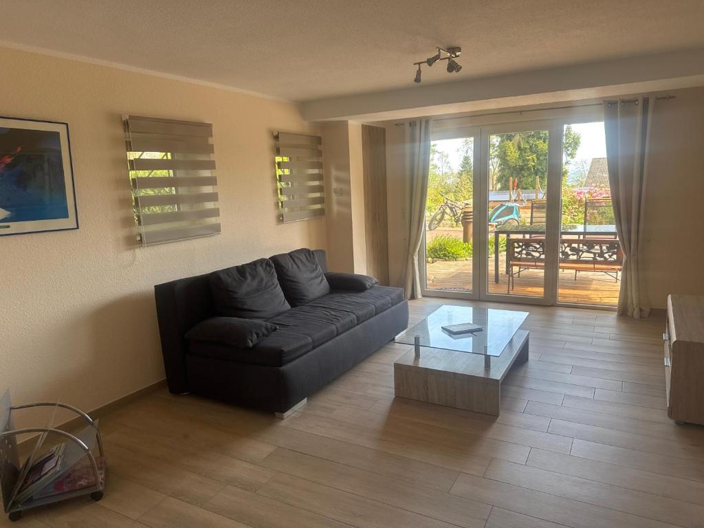 a living room with a couch and a coffee table at Fewo Eckernförde mit Meerblick in Eckernförde