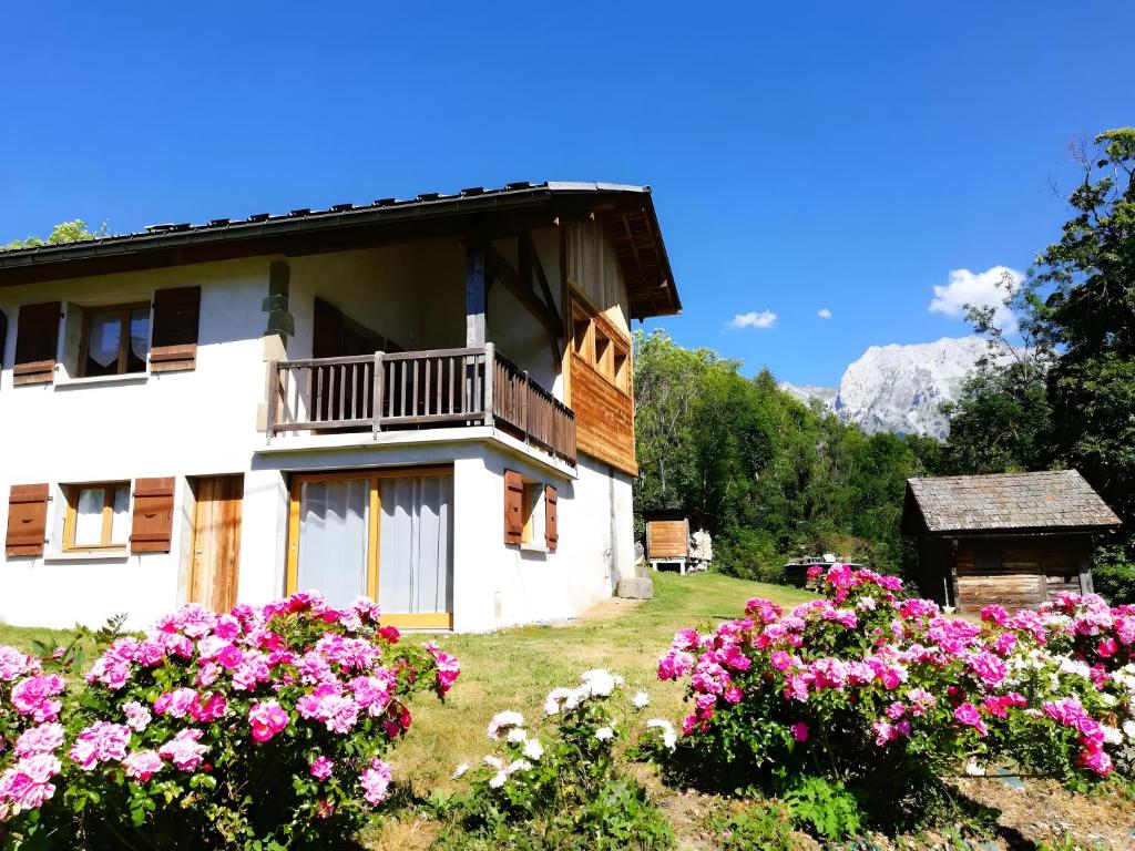 a house with pink flowers in front of it at Gîte La Clé Des Champs in Manigod