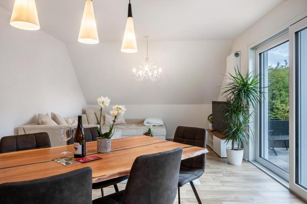 a dining room with a wooden table and chairs at Fewo Ebringen Weinbergblick in Ebringen