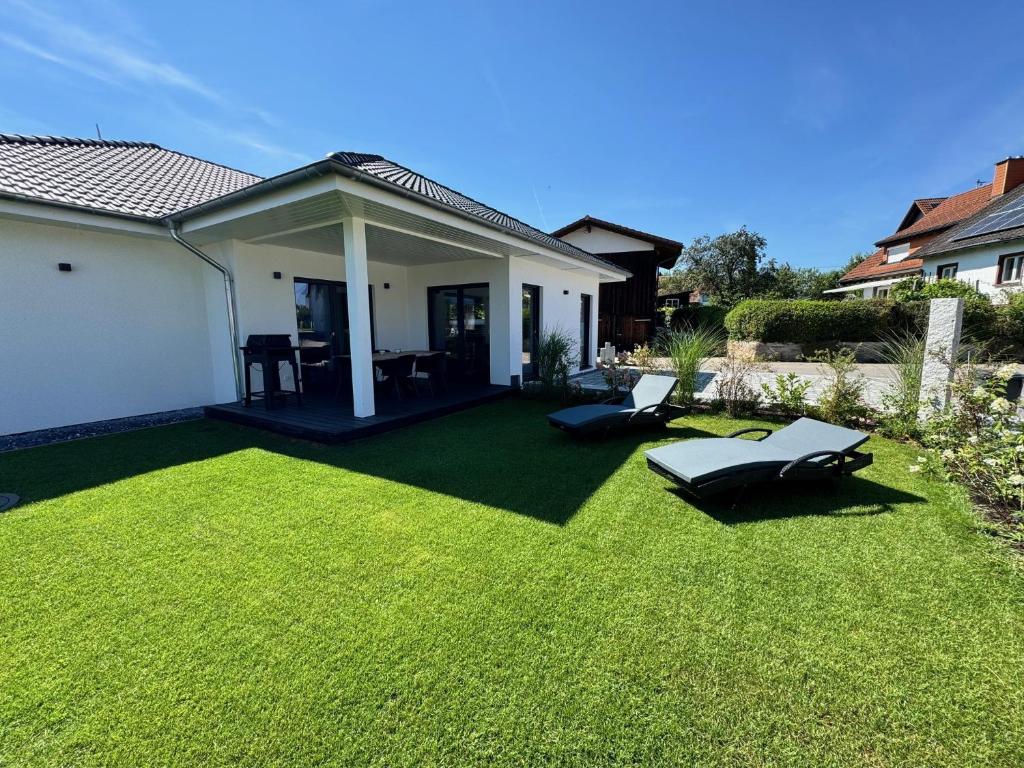 a yard with green grass and a house at Ferienhaus Lencer in Ühlingen-Birkendorf