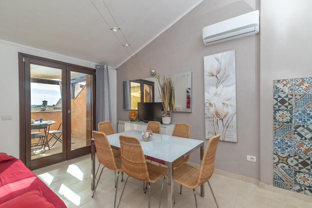 a dining room with a table and chairs at C 306 Attico Puntavilla Mare in La Maddalena
