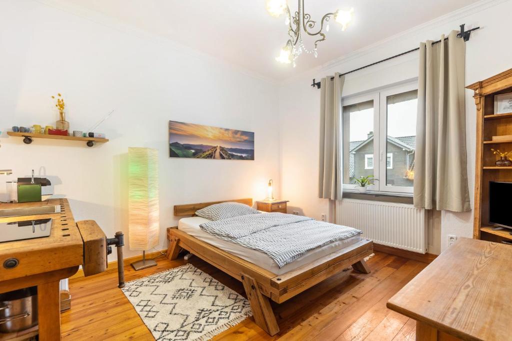 a bedroom with a bed and a desk at Apartment zur alten Post in Ulrichstein