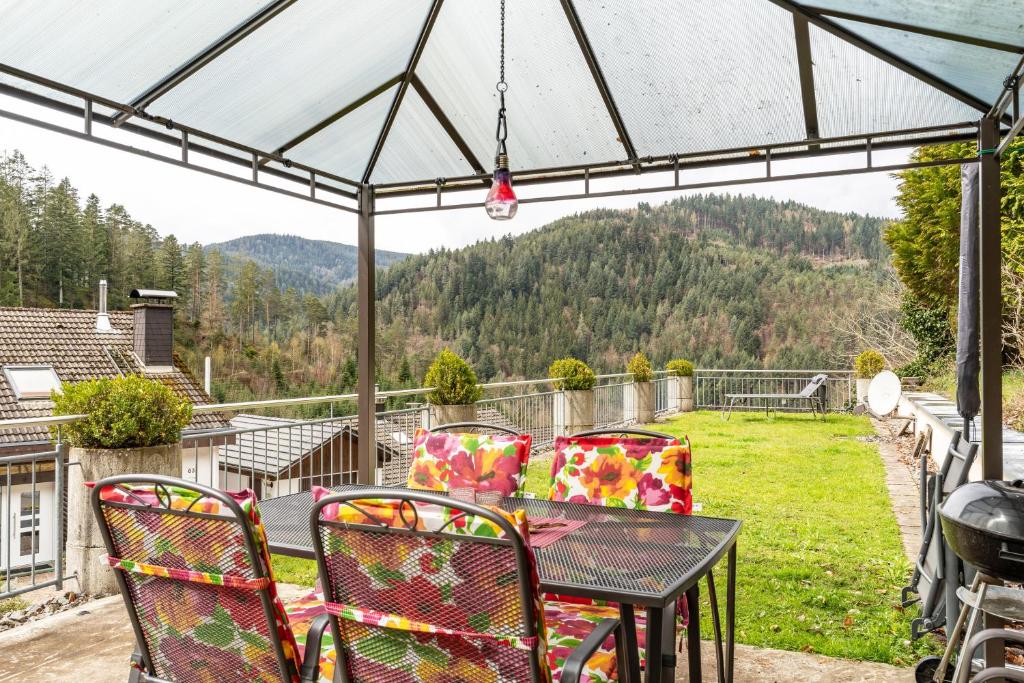 a table and chairs on a patio with a view at Ferienhaus Brigitte in Hornberg