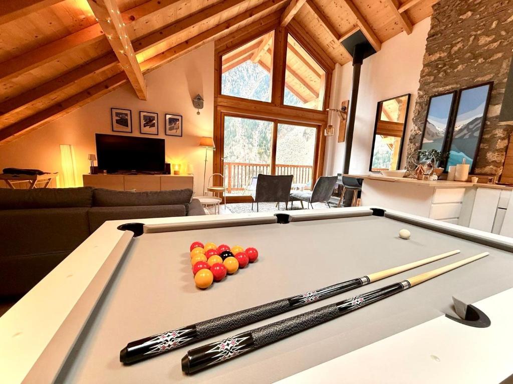 a pool table with cue balls on top of it at Duplex Sauna privé Vénosc Le 1618 in Les Deux Alpes