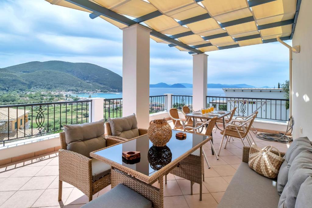 a living room with couches and tables on a balcony at Panorama apartment 2 in Póndi