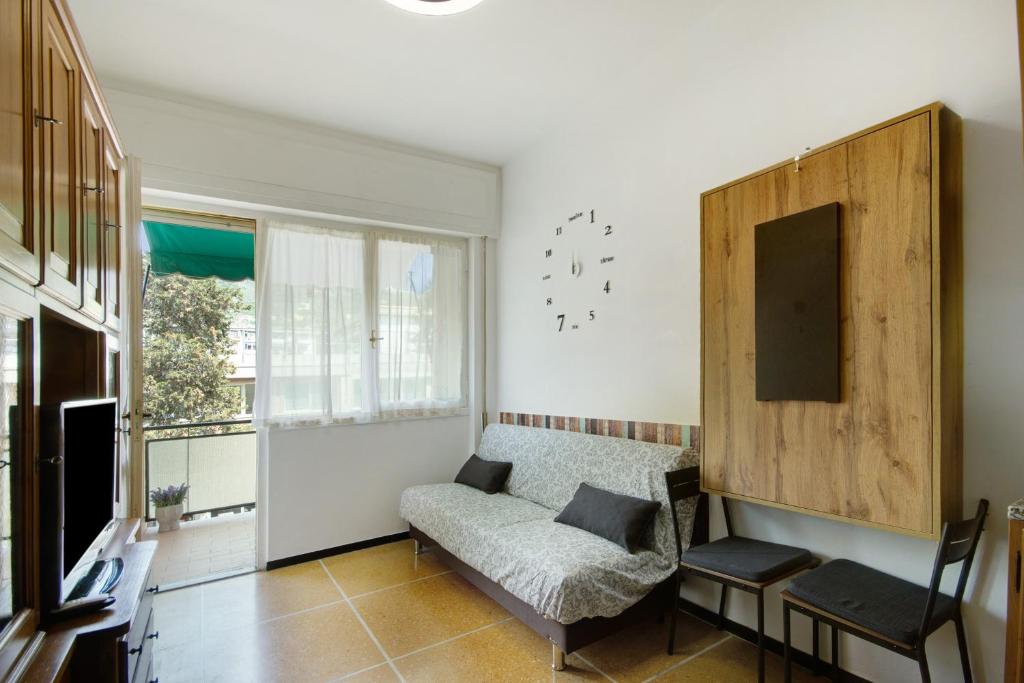 a living room with a couch and a chair at Casa Dica in Rapallo