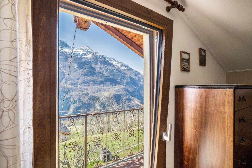 a window with a view of a mountain at La Mansarda di Chiara e Silvio in Trasquera