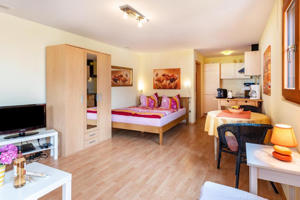 a room with a bed and a living room at Hach in Sulzburg