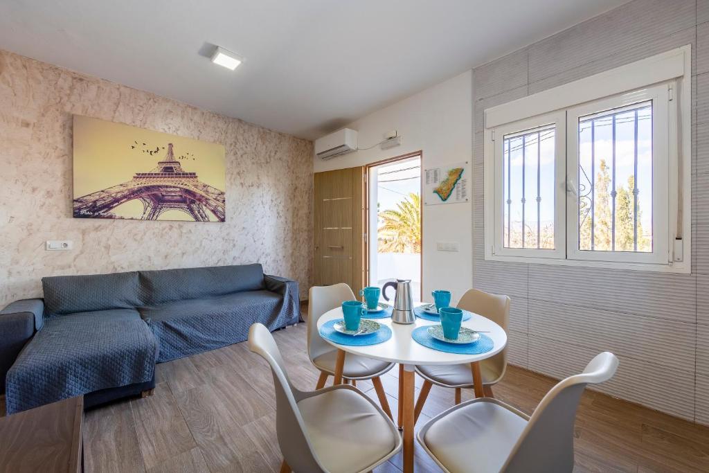 a living room with a couch and a table and chairs at Citronela in Níjar