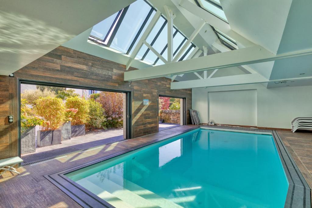 an indoor swimming pool in a house with a skylight at Villa Ker Minet - Hoedic - 6 pers in Piriac-sur-Mer