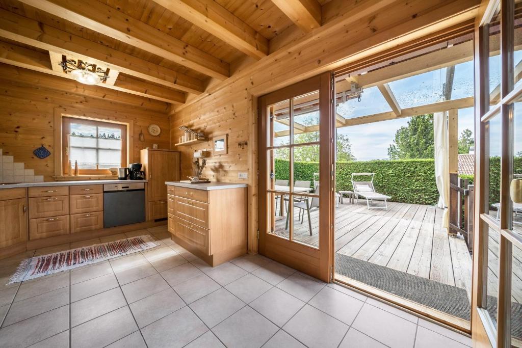 a kitchen with a large sliding glass door and a patio at Bergchalet Fuchsberger in Verano