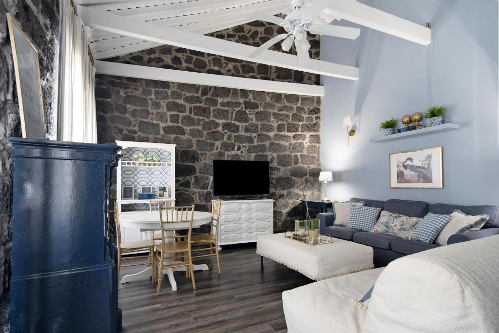 a living room with a couch and a table at Pico Boutique House in Lajes do Pico