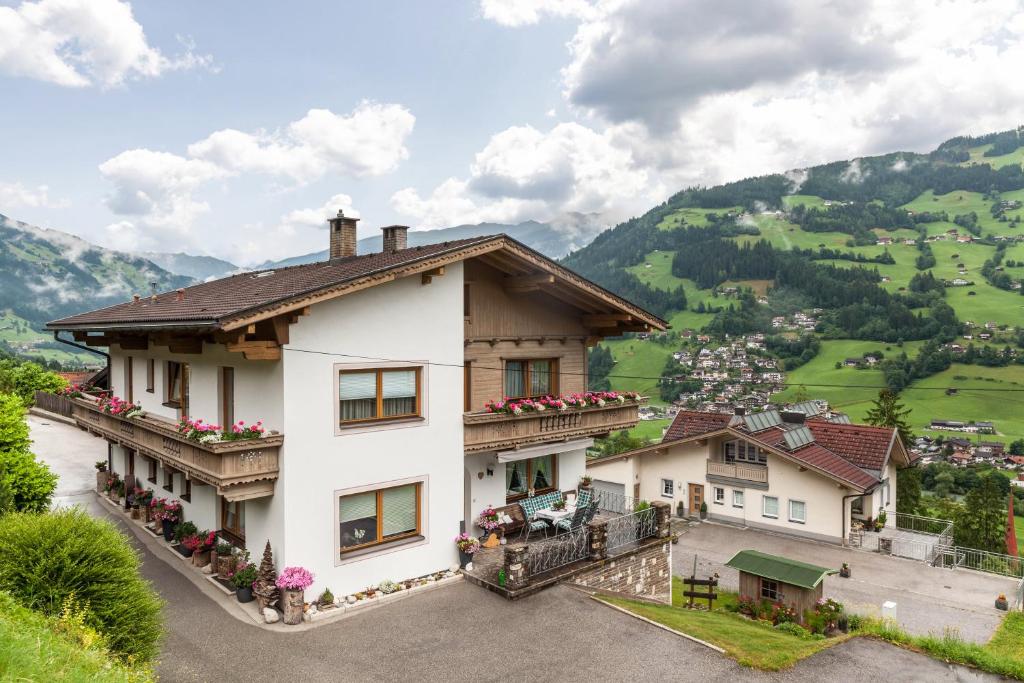a white house with balconies and a valley at Ferienwohnung Dornauer in Hippach