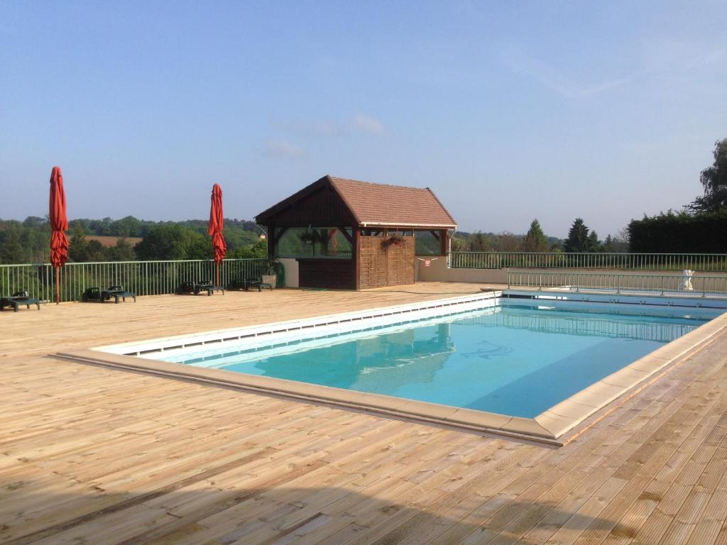 a swimming pool with a gazebo on a wooden deck at La résidence du vieux four in Saint-Geniès