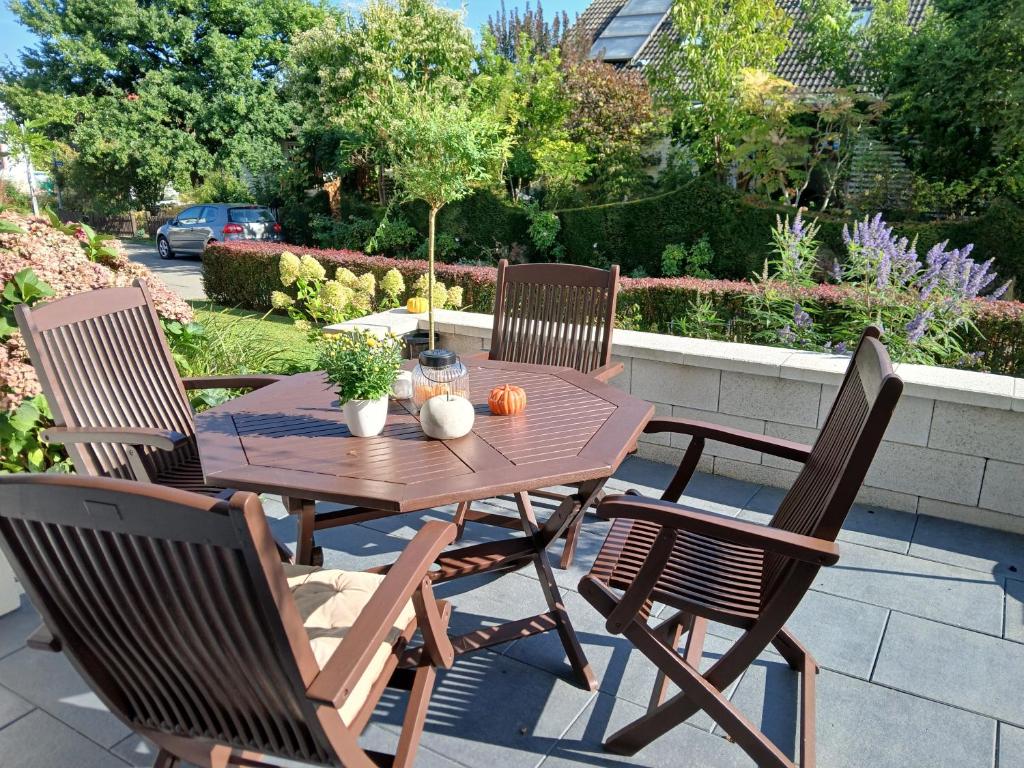 a wooden table and four chairs on a patio at Apartment Flora in Stockach