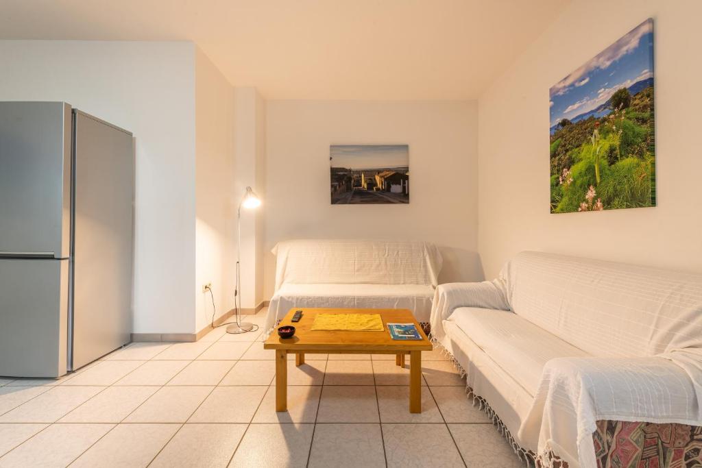 a living room with two beds and a coffee table at Casa Colonia 2 in SantʼAnna Arresi