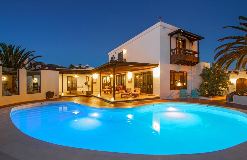 a large swimming pool in front of a house at Villa Haere Mai in La Asomada
